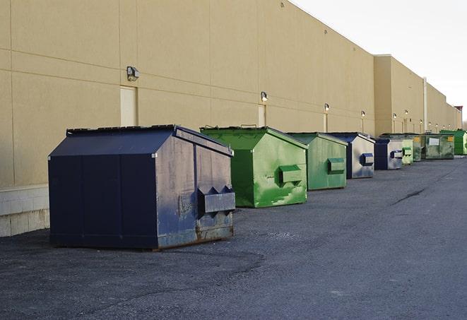 a construction worker moves construction materials near a dumpster in Columbiana AL